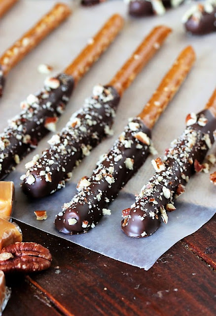 Turtle Pretzel Rods Dipped in Caramel and Chocolate Sprinkled with Pecans Image