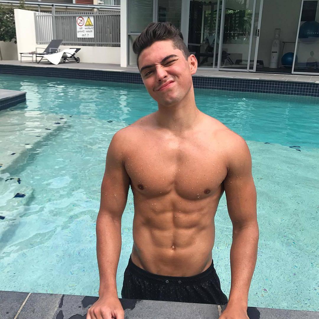 cute-teen-college-boy-winking-bare-chest-fit-wet-body-abs-pool