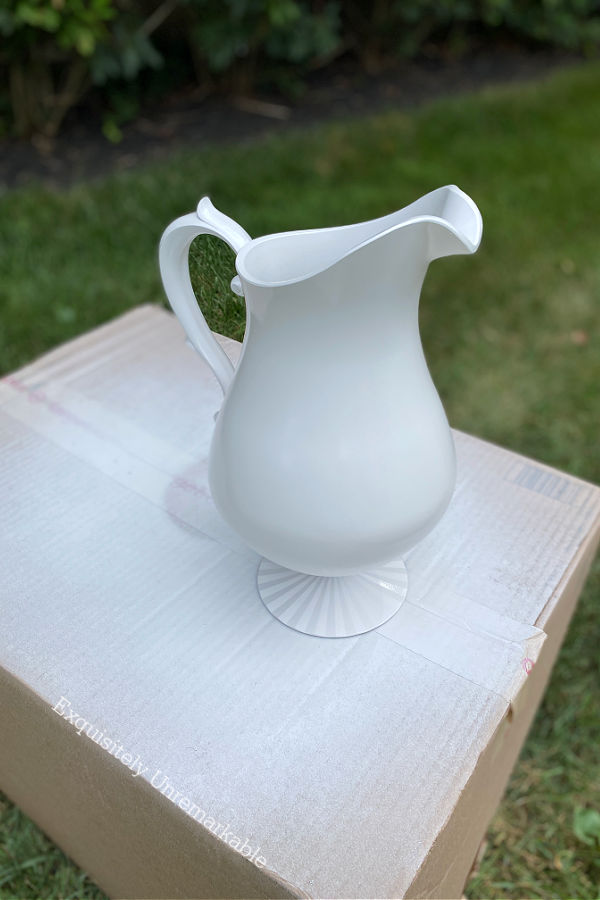 White spray painted plastic pitcher on cardboard box