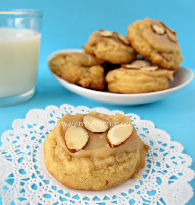 Almond Pudding Cookies with Brown Sugar Frosting on doilie and white plate