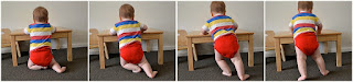 Baby getting to standing at furniture