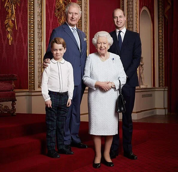 The photo shows the Prince of Wales, the Duke of Cambridge and Prince George standing with the Queen at Buckingham Palace