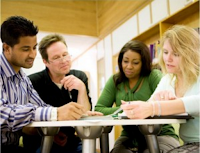 Four adults talking around table