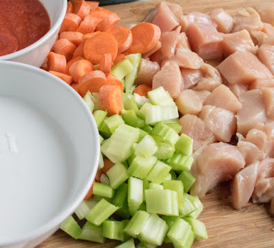 cutting board with diced celery, carrots and chicken