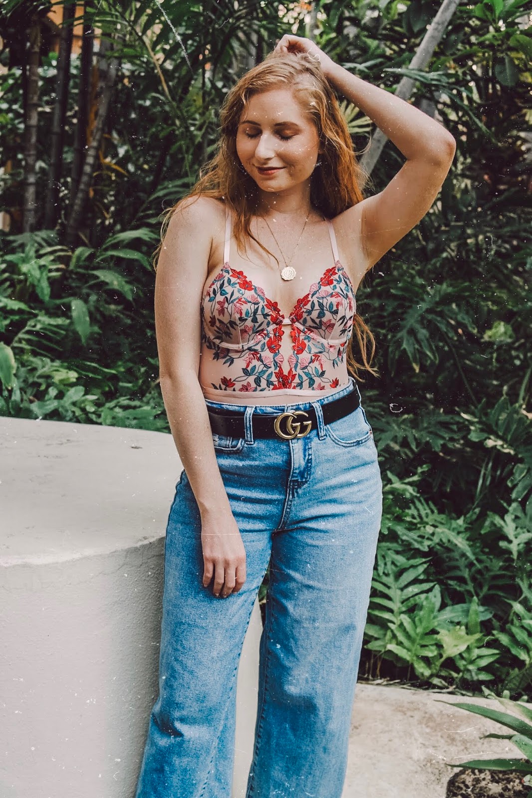 tampa blogger amanda burrows - wearing a floral bodysuit from forever 21 in oahu, hawaii - on a girls' trip for gal getaway by kahlea nicole - wearing a pair of wide-leg denim jeans from target - long hair from barefoot blonde extensions - wearing a gucci belt from amazon.