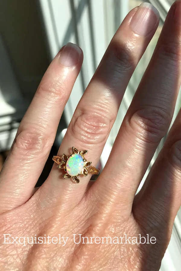 Yellow gold Opal Ring on woman's ring finger. 