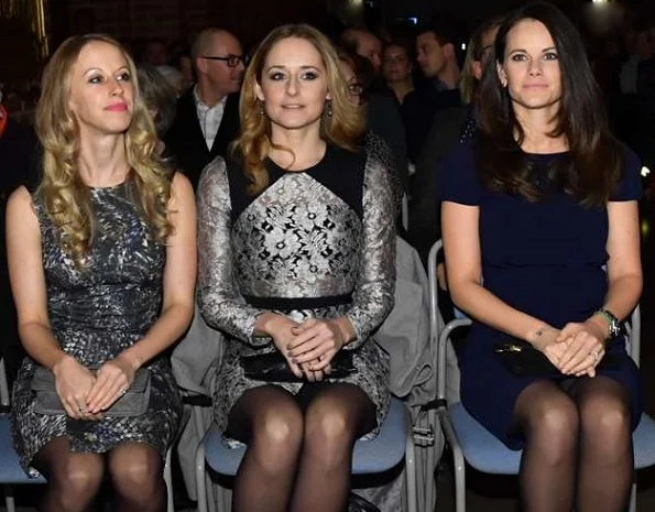 Princess Sofia, Sara Hellqvist and Lina Hellqvist at Christmas concert in Stockholm. Princess wore PRADA Knee length dress, Grece clutbag, gold bracelet, diamond rings and diamond gold earrings