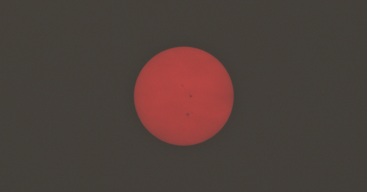 Eerie Red Sun Through Clouds with Visible Sunspots [Stellar Neophyte Astronomy Blog]