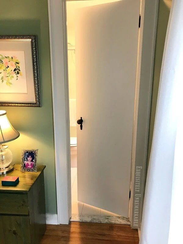 Cottage Style Bathroom Door in a green master bedroom