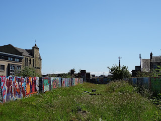Site of the railway that led to the bridge - now a grassy area with heavily graffitied brick walls running alongside. Photo by Kevin Nosferatu for the Skulferatu Project