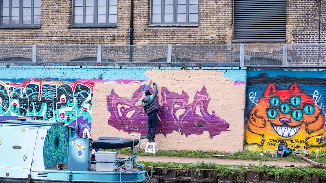 graffiti artist at work, East London, street art, canalside