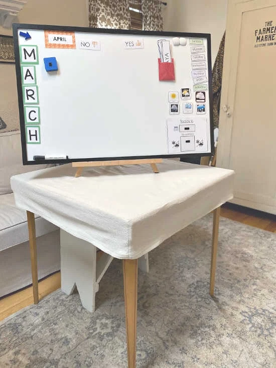 Whiteboard easel on top of tablecloth and card table
