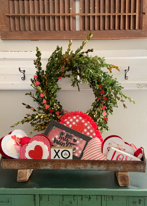 Paper Heart banner placed around boxwood wreath