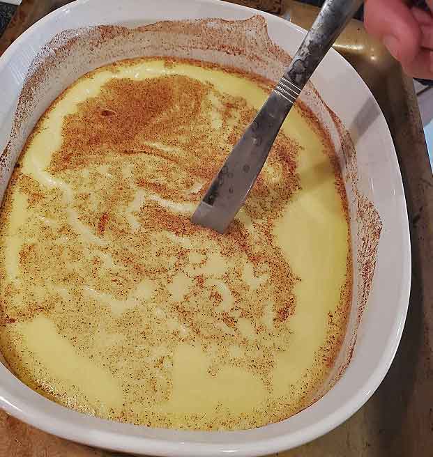 baked custard in a large white oven proof casserole dish