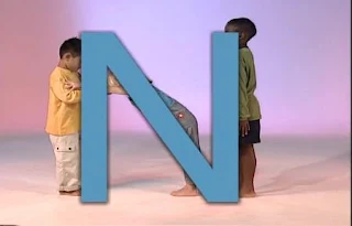 Three children form the letter N with their bodies. Sesame Street All Star Alphabet