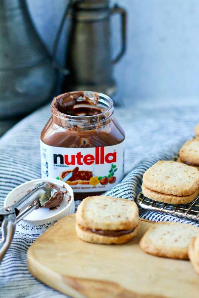 Hazelnut shortbread cookies with Nutella filling Cookies sandwiched together