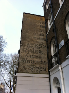Ghost sign for Bates Salves, Cures Wounds & Sores, Regent Square, London WC1