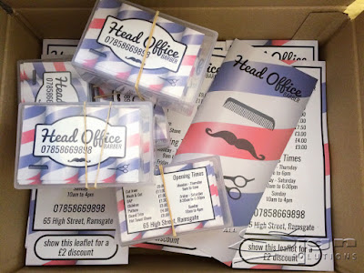 Photo showing the box full of leaflets and business cards for Head Office Barber. The phone number is in a hipster style font reading 07858669898.