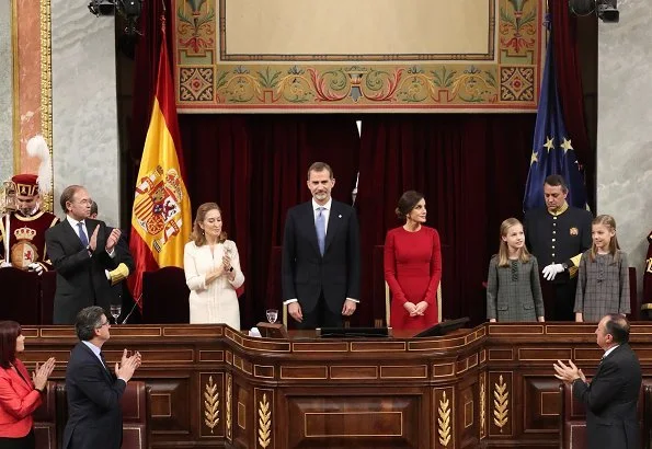 Queen Letizia wore Carolina Herrera red dress and clutch, Magrit pumps. Princess Leonor, Infanta Sofía and Queen Sofia