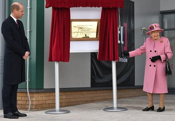 Queen Elizabeth wore a pink coat by Stewart Parvin and matching hat by Rachel Trevor-Morgan. Carved Ruby, gold and diamond brooch, Grima ruby brooch