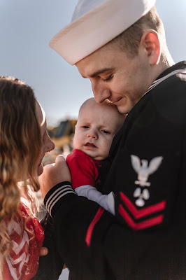 Military Sailor meeting baby for the first time at Naval Base Point Loma, California . Images by Morning Owl Fine Art Photography. 