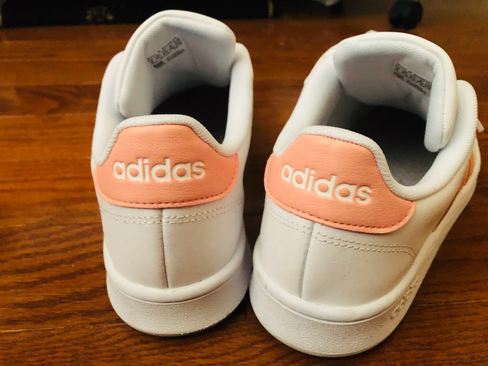 white adidas trainers with pink stripes
