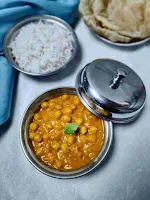 Serving chole with rice and puri for chole recipe