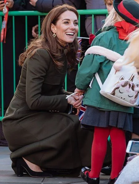 Kate Middleton wore a green Alexander McQueen coat, a print dress by Zara, Zeen ceramic earrings and Aspinal of London Mayfair bag