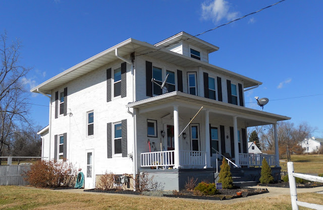 white 2-story house with black shutters: Aladdin Charleston at 10527 Hamilton Avenue Cincinnati Ohio
