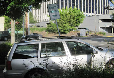 Sign above a parked car that says Fancy Parking Only