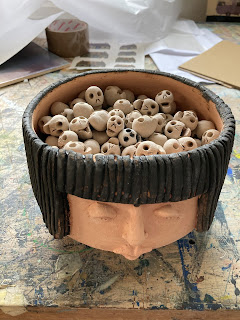 A batch of Skulferatus in a head waiting to go into the kiln to be fired