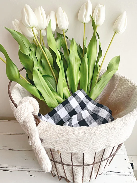 long stemmed white tulips in a lined clam basket