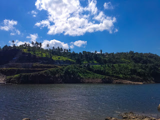 Lake Water Of Titab Ularan Dam And The Hill Of Farming Lands On A Sunny Day In The Dry Season North Bali Indonesia