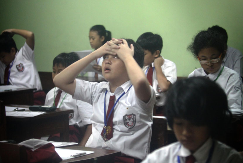 Image of students sitting in a classroom and working on a test