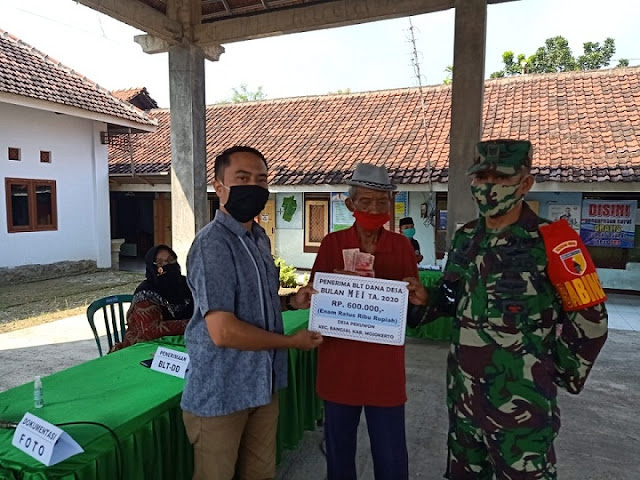 Babinsa Koramil 0815/10 Bangsal Bantu Kelancaran Penyaluran BLT Dana Desa Mojokerto, - Babinsa Koramil 0815/10 Bangsal Kodim 0815/Mojokerto Serda Imam Supi’i mendampingi sekaligus membantu kelancaran penyaluran Bantuan Langsung Tunai (BLT) Dana Desa (DD) Tahap II, di Balai Desa Sumbertebu Kecamatan Bangsal Kabupaten Mojokerto, Jawa Timur, Jum’at (19/06/2020). Pantauan Babinsa di lapangan, penyaluran BLT DD Tahap II dilakukan Sekdes Hans Chandra Erlangga serta dihadiri perangkat desa setempat. “Penyaluran BLT DD Tahap II ini diperuntukan bagi 10 orang warga dan dilakukan secara bergantian dengan mengedepankan protokol kesehatan” terang Serda Imam Supi’i. “Pembagian Bantuan Langsung Tunai Dana Desa Tahap II ini besaran nominalnya sama dengan tahap pertama, sejumlah Rp 600.000, - per KK, dengan tujuan untuk membantu meringankan beban warga kurang mampu yang terdampak Covid-19,” tambah Babinsa. Masih di wilayah Kecamatan Bangsal, kegiatan serupa juga berlangsung di Desa Pekuwon oleh Kepala Desa Pekuwon, Kharisma Utomo, dengan didampingi Babinsa setempat Serka Marthen serta perangkat desa. Penyaluran BLT DD Tahap II tersebut diperuntukan bagi 69 warga, dengan besaran nominal Rp 600.000,- per KK. Terpisah Danramil 0815/10 Bangsal Kapten Inf Mujiono, mengungkapkan, pembagian BLT, BLT Dana Desa maupun bantuan lainnya merupakan wujud perhatian sekaligus kepedulian pemerintah terhadap masyarakat, guna meringankan beban ekonomi warga kurang mampu yang terdampak Covid-19. “Kehadiran Babinsa dalam kegiatan tersebut, guna mendampingi dan membantu kelancaran sekaligus mengamankan agar program pemerintah maupun pemerintah desa berlangsung aman,” ungkapnya. (Jayak)