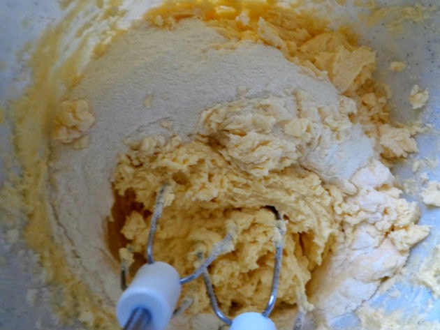 Add the flour mixture in two batches to the butter and eggs mixture.