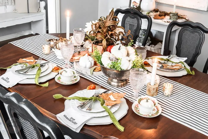 Thanksgiving tablescape with velvet, metals, candles, pumpkins and florals