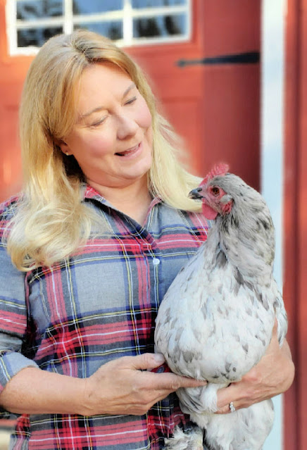 woman holding chicken