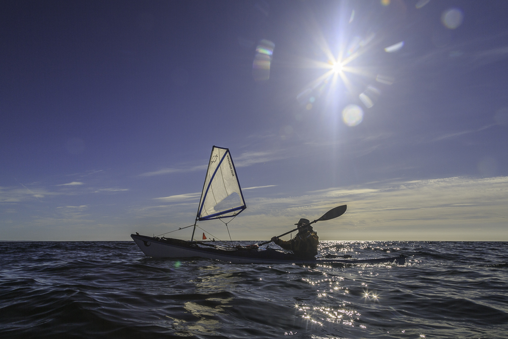 Sea kayaking with Assisted reentry after a capsize with a Flat Earth kayak sail.
