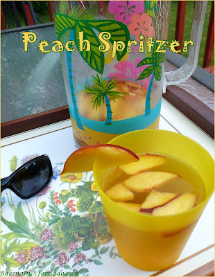 Peach Spritzer, a fruity summer version of a wine spritzer. A cool refreshing drink for a hot summer night. | Recipe developed by www.BakingInATornado.com | #recipe #cocktail