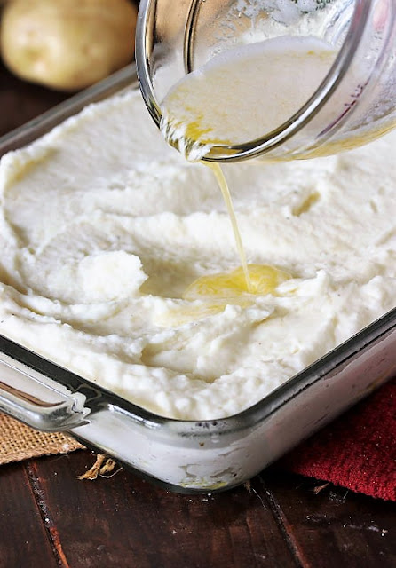 Pouring Melted Butter on Mashed Potatoes Image