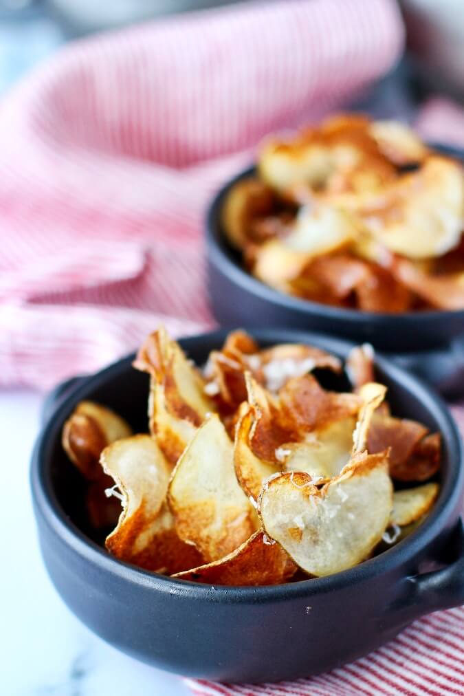 Homemade parmesan potato chips Homemade parmesan potato chips in bowls