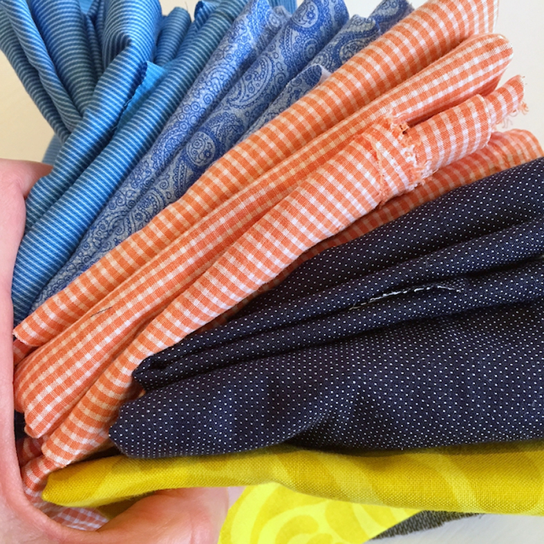 Handful of fabrics for the Lockstep quilt
