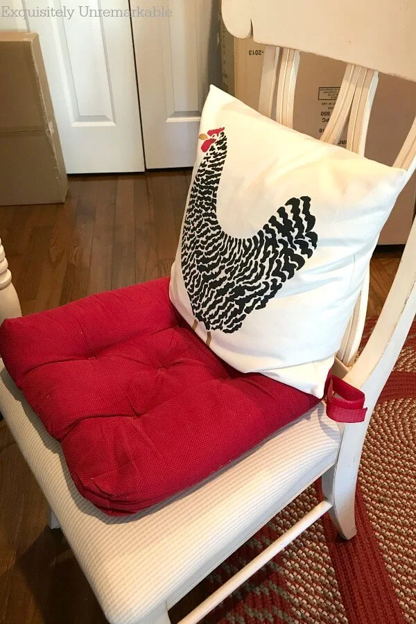 Makeshift Desk Chair with red pad and rooster pillow