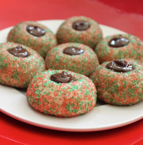 Food Lust People Love: These pretty little chocolate-filled Christmas thumbprint cookies are a mouthful of wonderful on a Christmas plate. Roll the dough into balls and coat them with sprinkles or colored coarse sugar, then bake and fill with melted chocolate when cool. Santa and his helpers will love these!