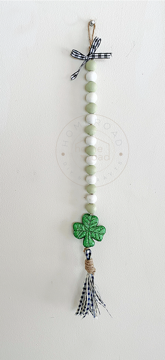 Green and white beaded garland with a shamrock and tassel