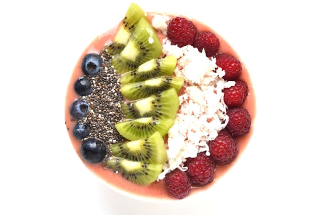 This Tropical Smoothie Bowl makes the perfect breakfast or snack with pineapple, mango and strawberries and tropical toppings! www.nutritionistreviews.com