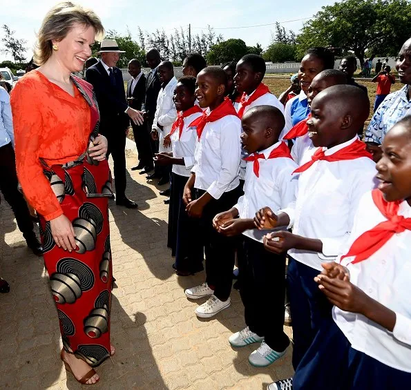 Queen Mathilde wore a red midi dress by Belgian fashion house Natan, and gold earrings by Natan