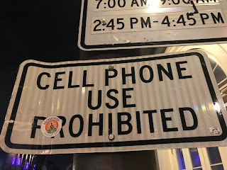 A street sign at the entrance to the New Orleans French Quarter prohibits the use of cellphones