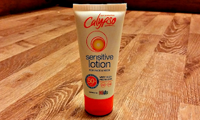 The tube of Calypso Sensitive Face and Neck Lotion on a wooden floor